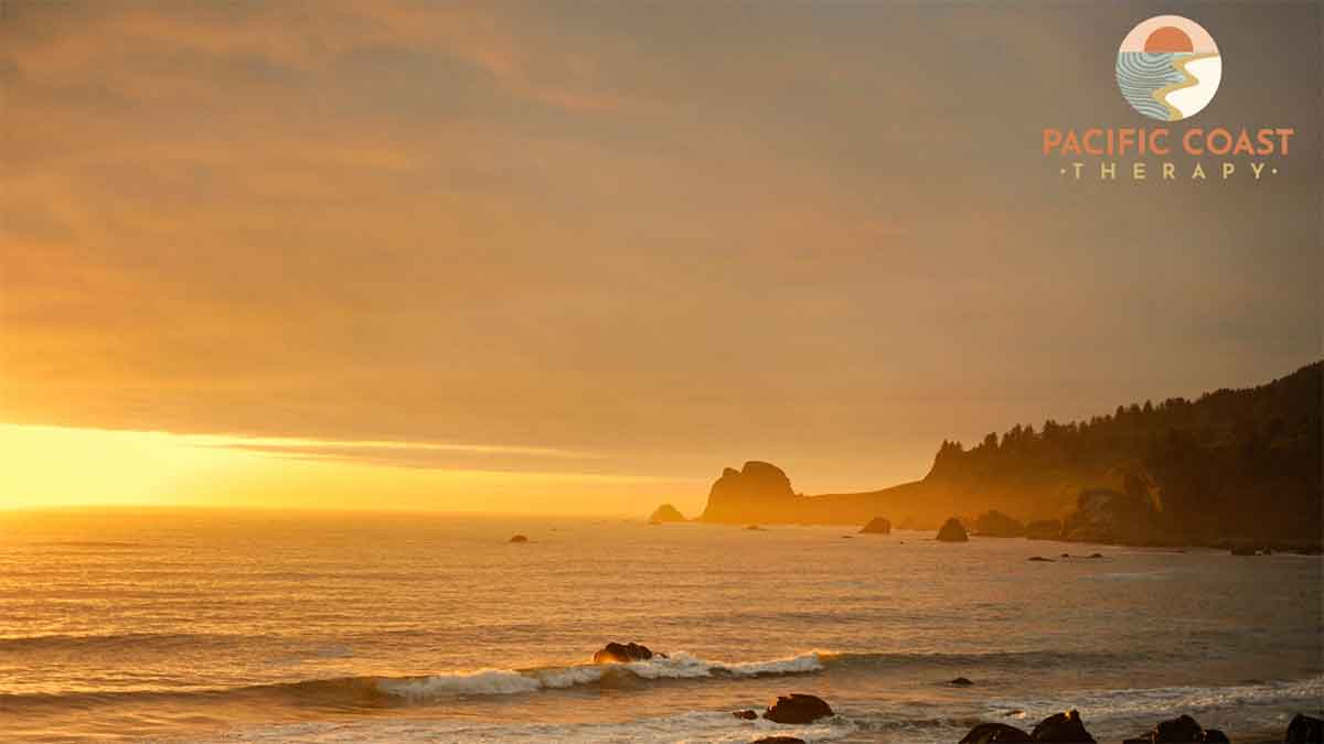 Coastal Sunset View Sun setting over the ocean with a calm coastline silhouette