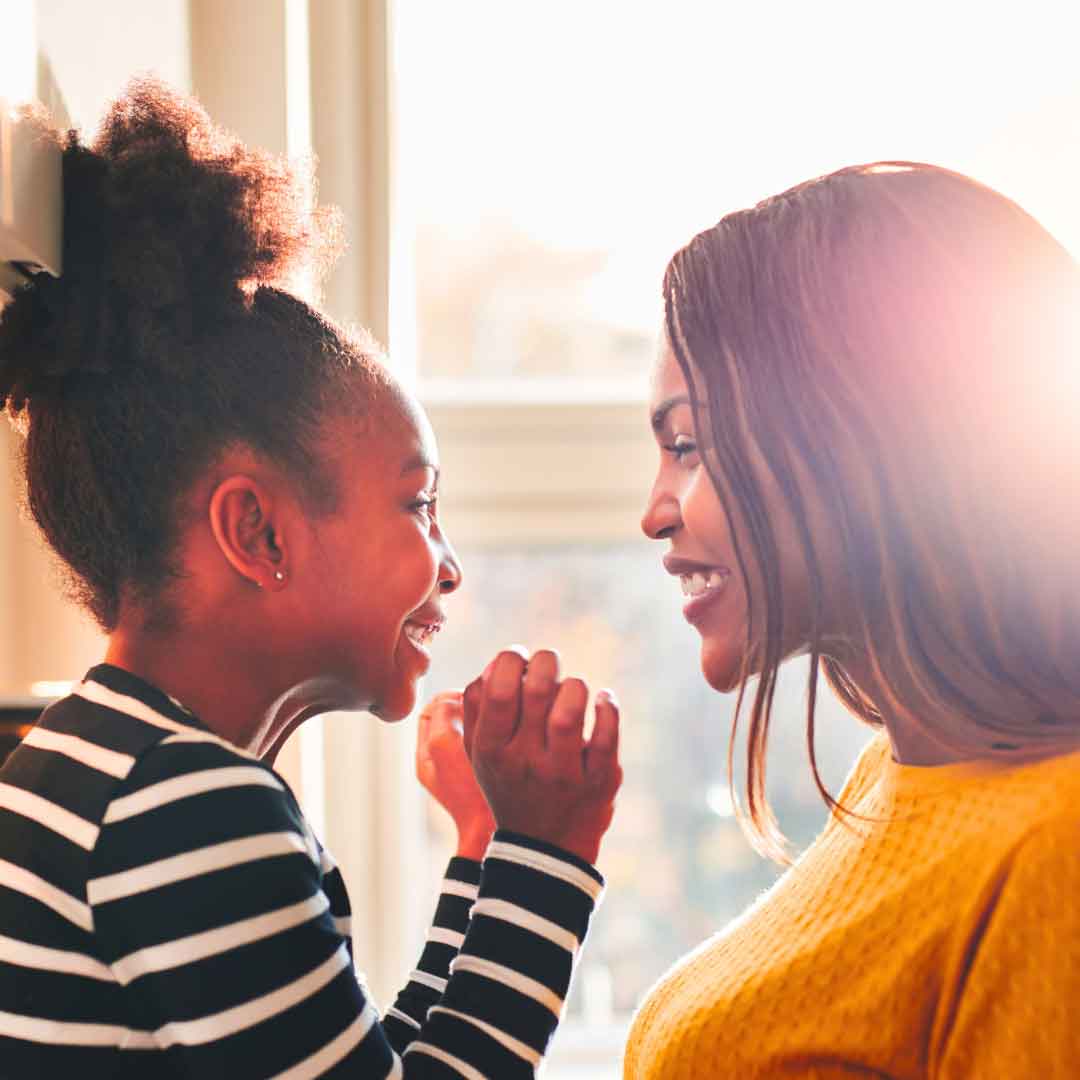 Happy Girl Talking to a Woman Smiling young girl having a cheerful conversation with an adult woman