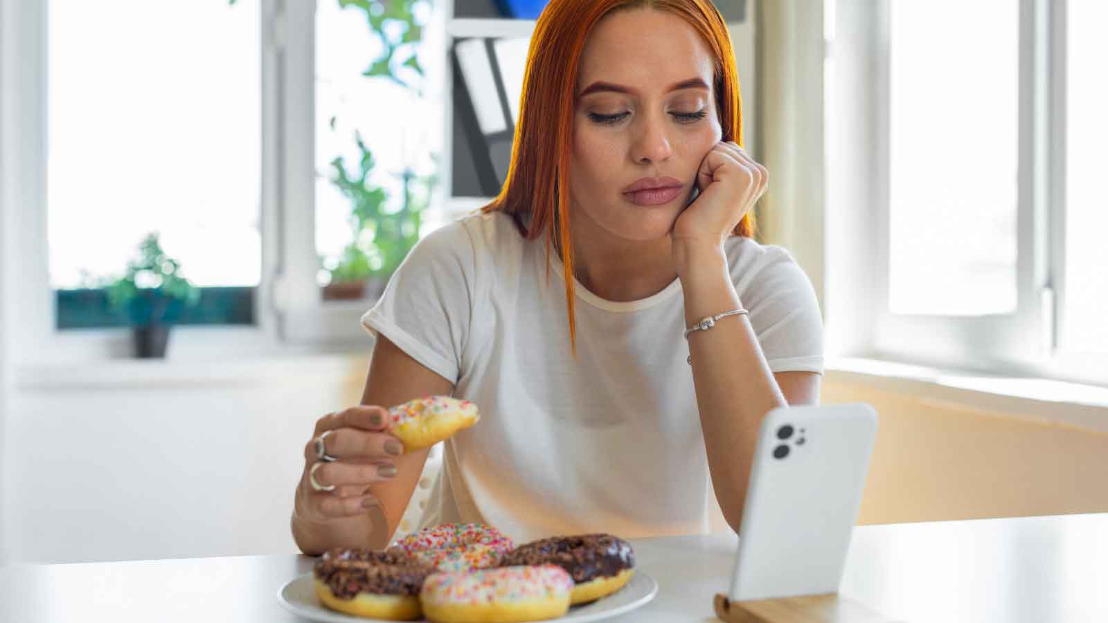 A-woman-binge-eating A woman binge eating.